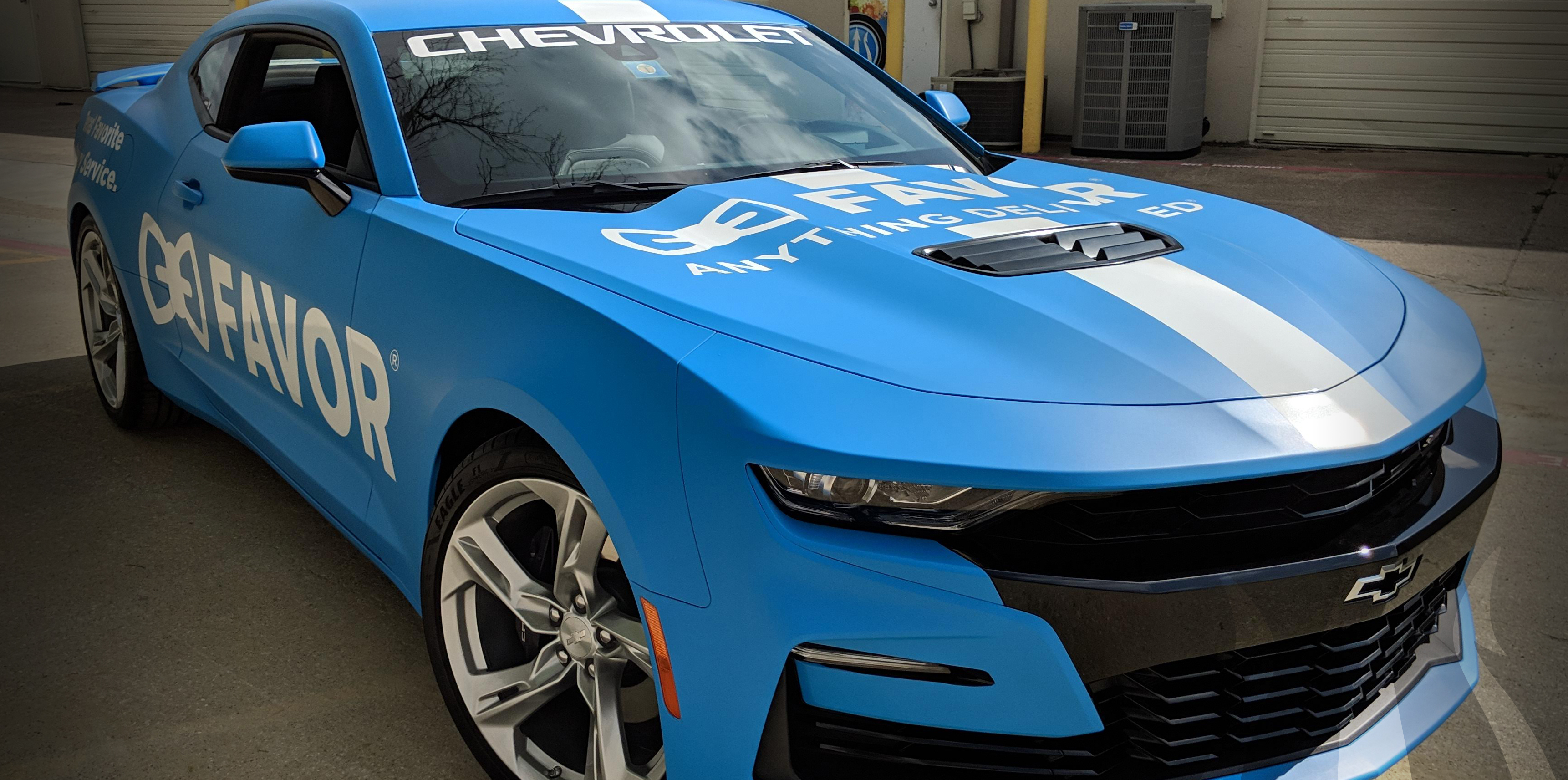 a light blue super car with a vehicle wrap in Frisco